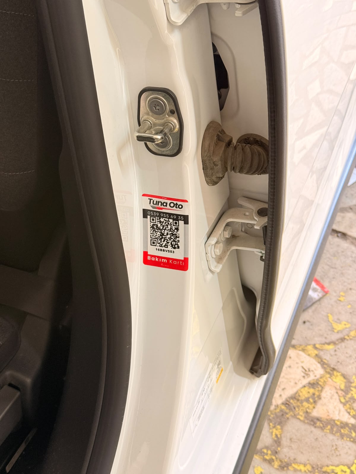 Oto servis QR bakım kartı — araç kapı kenarına yapıştırılmış plaka QR etiketi